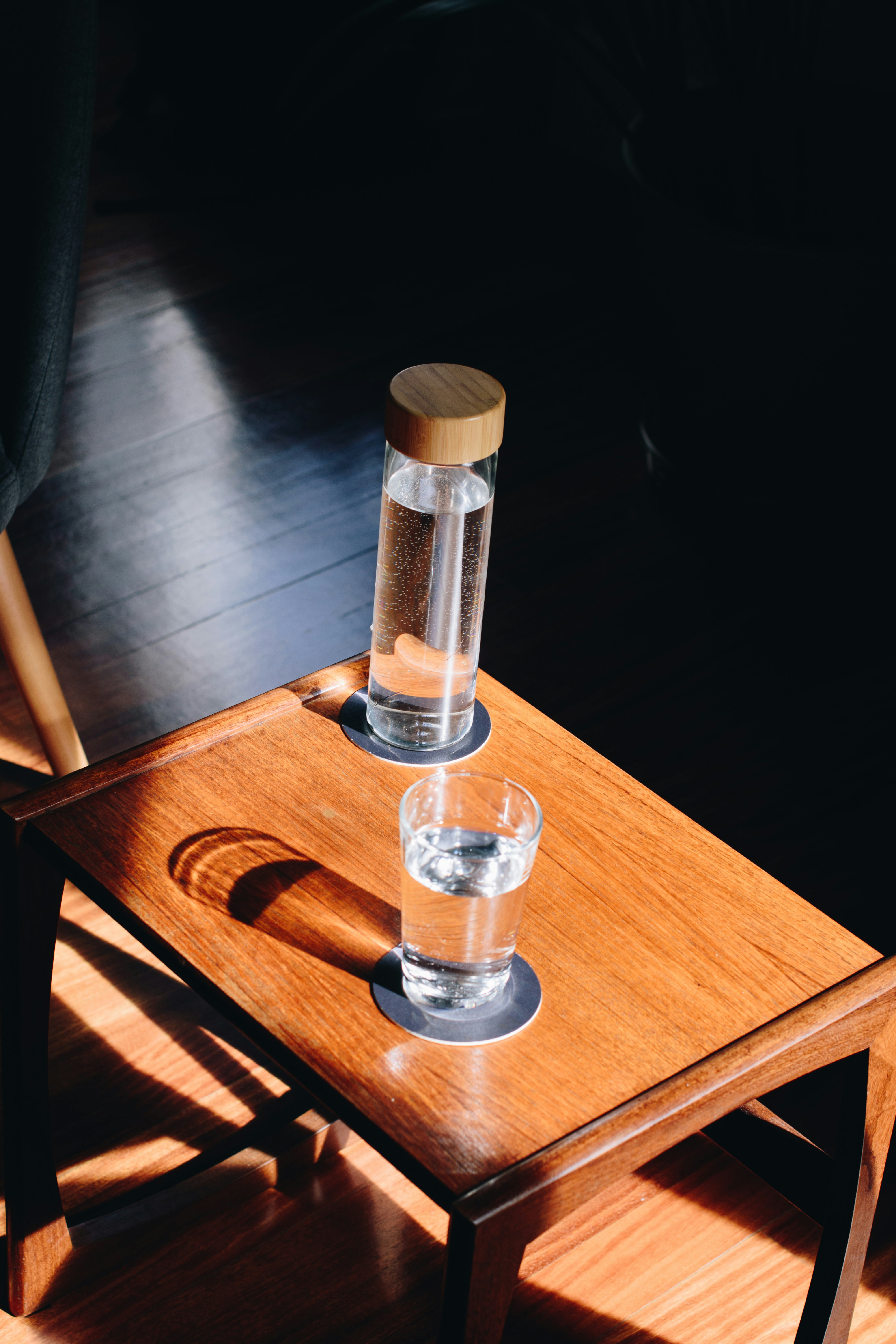 clear drinking glass on brown wooden table